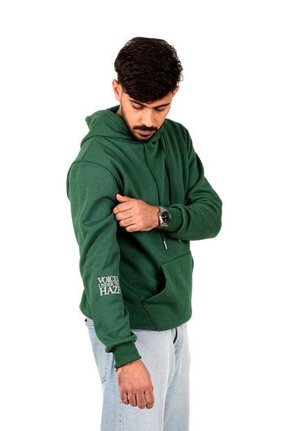 Man wearing a green hoodie with text on a white background