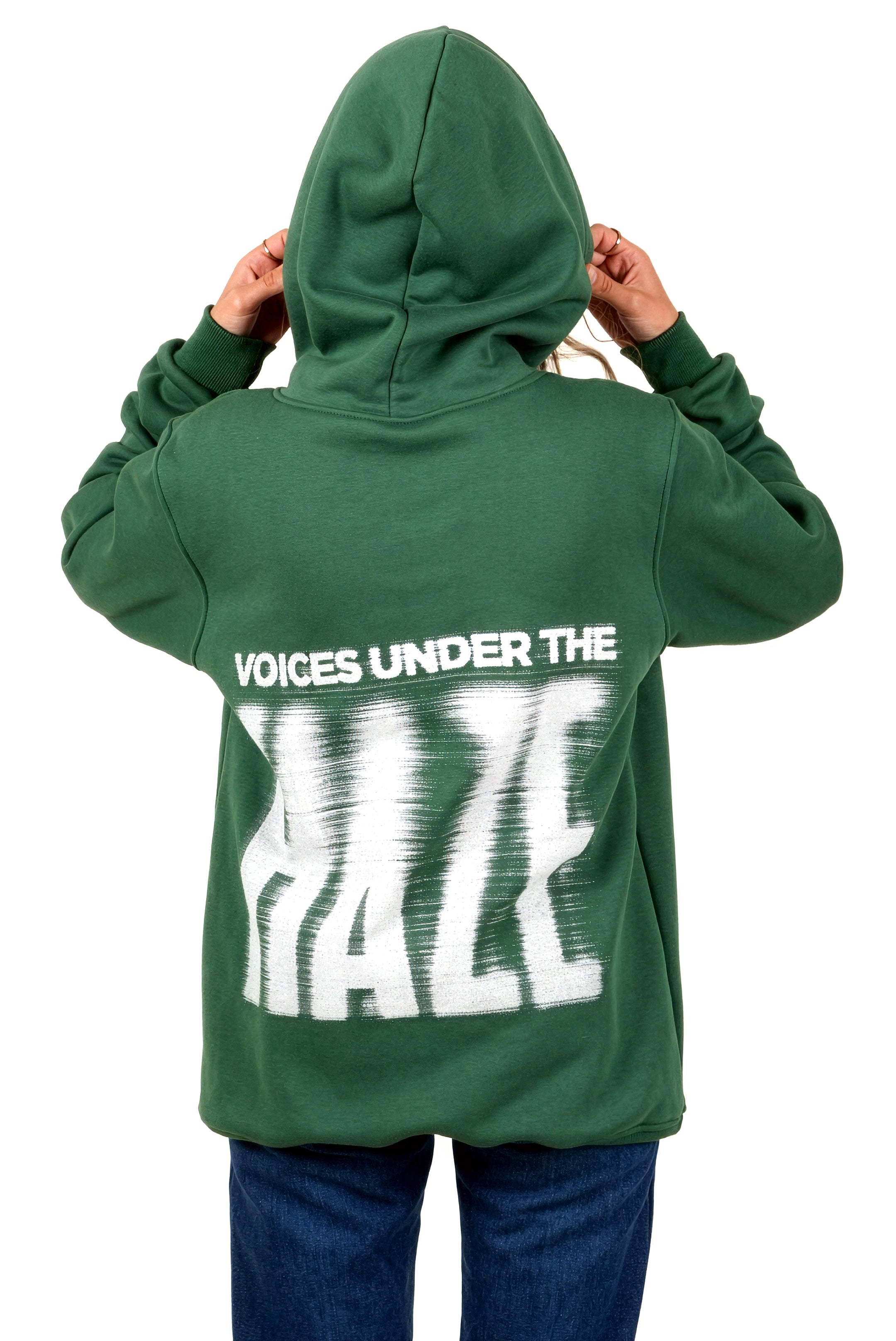 Green hoodie with 'Voices Under the Haze' text on the back, worn by a person.
