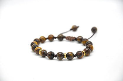 Beaded bracelet with brown and yellow tiger eye stones on a white background