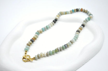 Necklace with small beads and a gold clasp on a white background