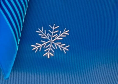 White snowflake design on a blue textured fabric background