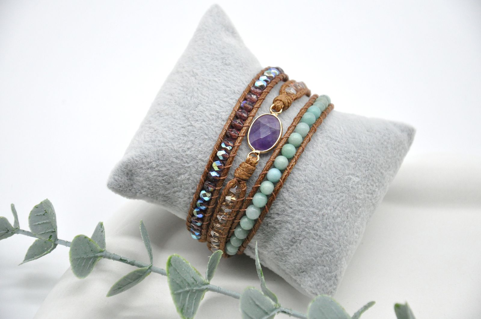 Set of bracelets on a gray cushion with a white background