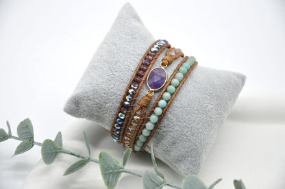 Set of bracelets on a gray cushion with a white background