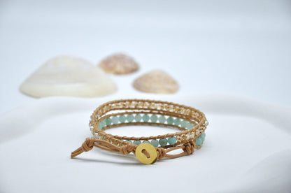Bracelet with beads and a button on a light background