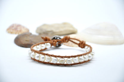 Pearl bracelet on a white background with seashells