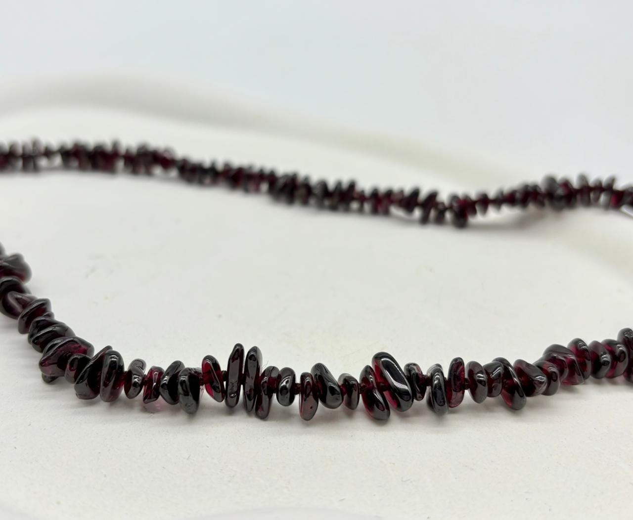 Necklace with dark red beads on a white background