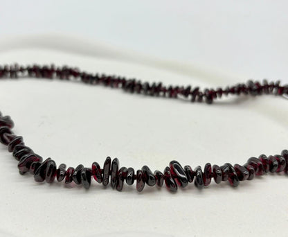 Necklace with dark red beads on a white background