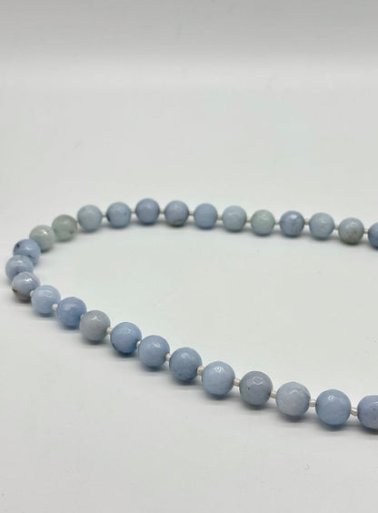 Necklace with blue beads on a white background