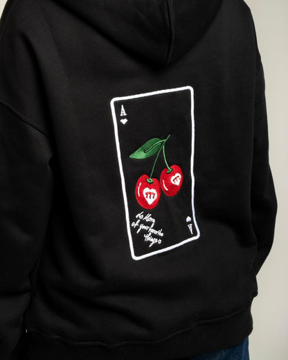 Black hoodie with a graphic design of cherries on the back