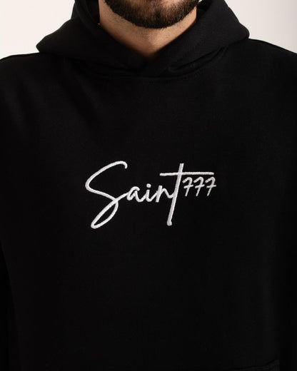 Black hoodie with 'Saint 777' logo on a plain background