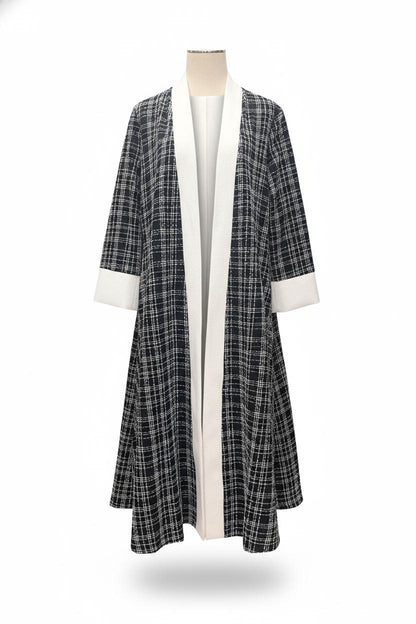 Plaid coat with white trim on a mannequin against a white background