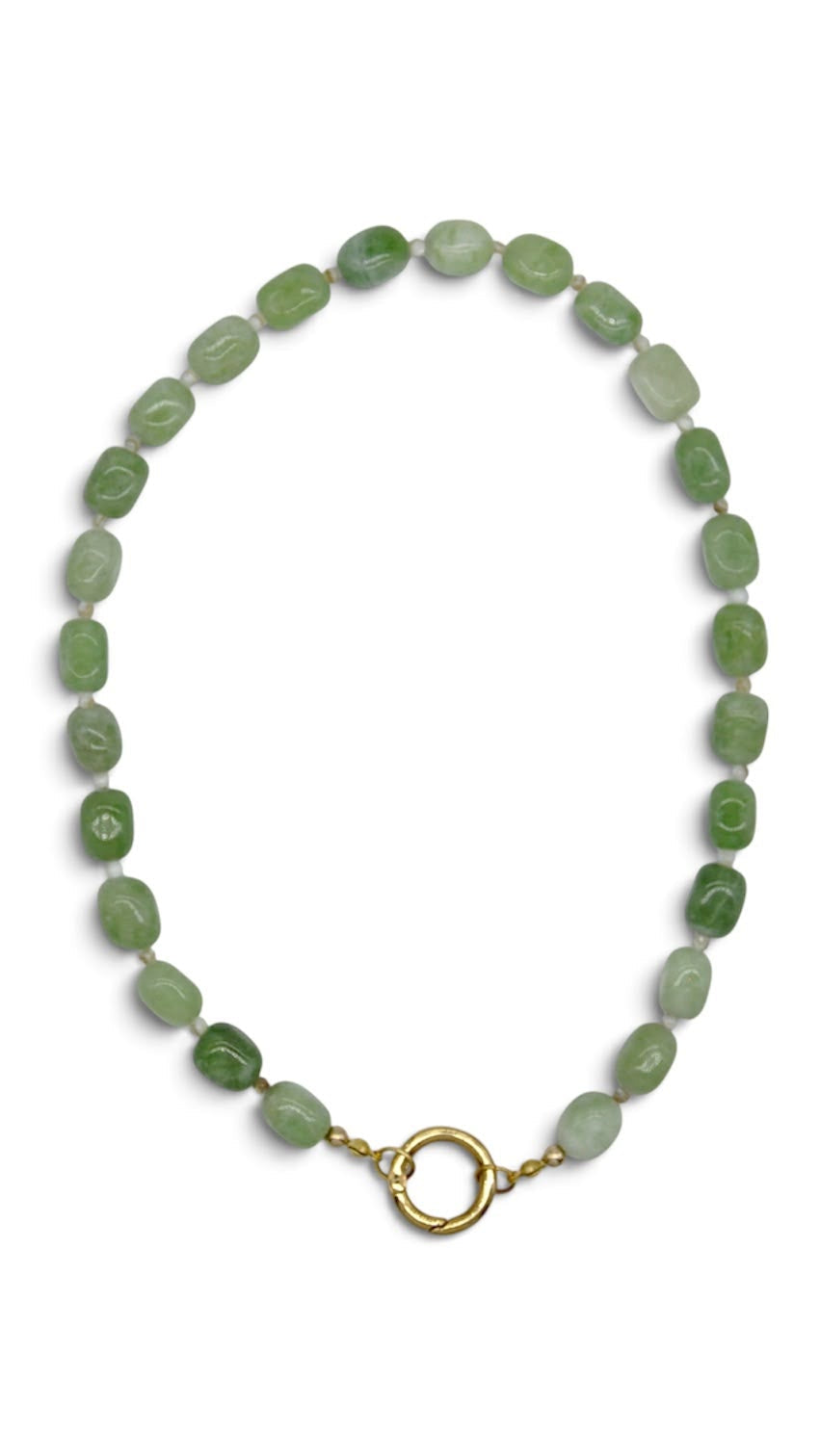 A beaded necklace made of small, irregular green stone beads with a gold-tone split ring clasp, displayed on a clean white background.