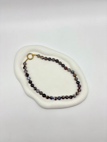 Beaded bracelet on a white stone surface