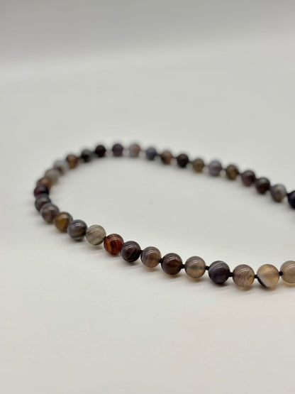 Necklace with multicolored beads on a white background