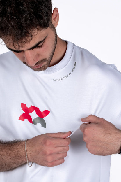 Person wearing a white t-shirt with a red and gray logo on a white background