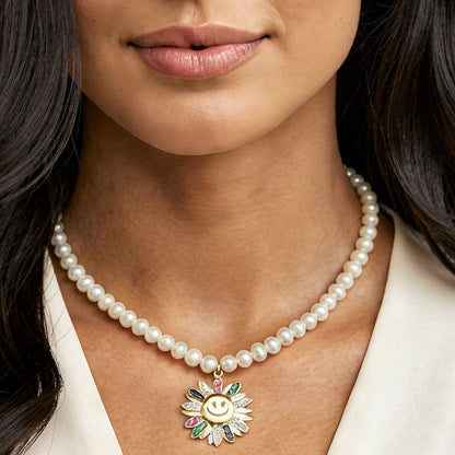 Woman wearing a pearl necklace with a decorative pendant on a white background