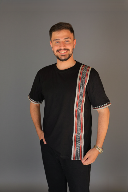 Man wearing a black shirt with a colorful stripe on a gray background