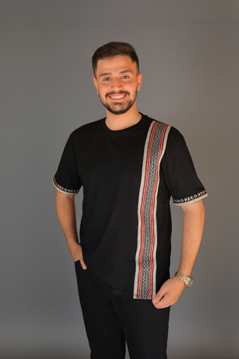 Man wearing a black shirt with a colorful stripe on a gray background