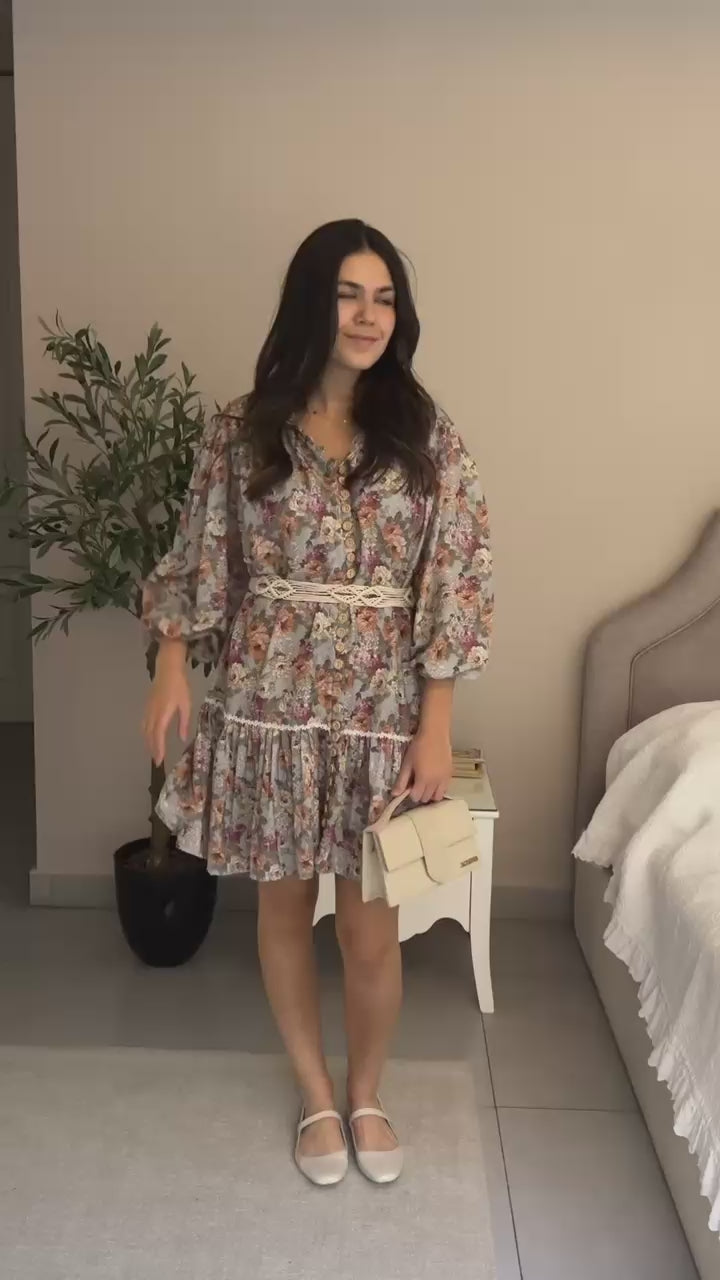 Woman wearing a floral dress with a belt on 